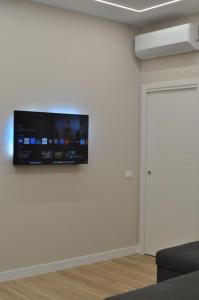 a flat screen tv on a wall in a room at La Terrazza di Luca B&B in Tavernelle