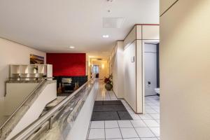 a hallway of a kitchen with a red wall at Relax Backnang Apartment in Backnang +16 photos