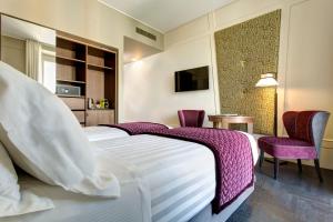 Postel nebo postele na pokoji v ubytování Mascagni Luxury Rooms & Suites