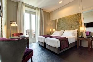 Postel nebo postele na pokoji v ubytování Mascagni Luxury Rooms & Suites