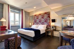 Postel nebo postele na pokoji v ubytování Mascagni Luxury Rooms & Suites