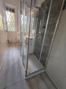 a bathroom with a shower with glass doors at Raggio di Sole in Loano