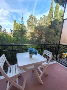 a white table and two chairs on a balcony at Raggio di Sole in Loano