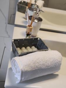 a basket of towels sitting on a bathroom counter at Raggio di Sole in Loano