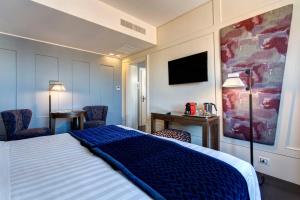 Postel nebo postele na pokoji v ubytování Mascagni Luxury Rooms & Suites