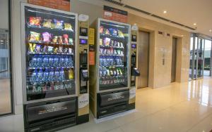 two soda vending machines in a shopping mall at Flat particular Vision Executive in Brasília