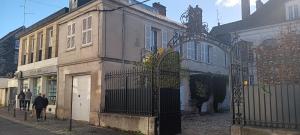an old building with a gate on a street at Gisors centre in Gisors