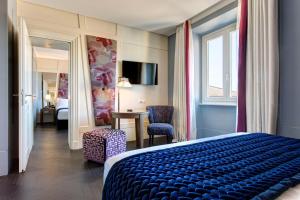 Postel nebo postele na pokoji v ubytování Mascagni Luxury Rooms & Suites