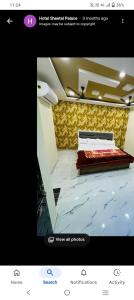 a picture of a bedroom with a bed in a room at Sheetal palce hotel in Ujjain