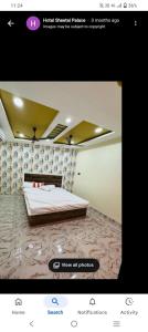 a screenshot of a bedroom with a bed in a room at Sheetal palce hotel in Ujjain