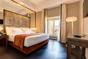 Postel nebo postele na pokoji v ubytování Mascagni Luxury Rooms & Suites