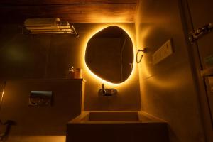 a bathroom with a sink and a mirror on the wall at Vanantara - Riverside Eco Retreat in Ernakulam