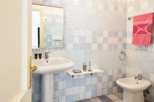 a bathroom with a sink and a toilet at Nido in Monte Petrosu +18 photos