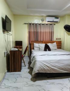 a bedroom with a large bed and a television at FMH Hotel in Ede +15 photos