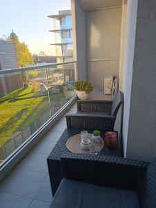 a balcony with two chairs and a table on a balcony at Studio Apartman Dalma in Ðakovo