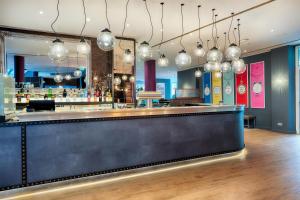 a bar in a restaurant with lights at Premier Inn Stuttgart Bad Cannstatt in Stuttgart