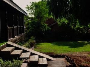 a set of steps leading to a yard with a house at The Nugget Guest Lodge in Kempton Park