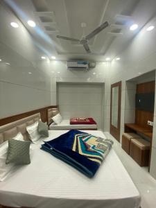 a bedroom with two beds and a ceiling at Sonu luxury residency hotel in Amritsar +17 photos