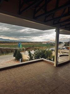 a patio with a view of a road and mountains at Twins in Korçë