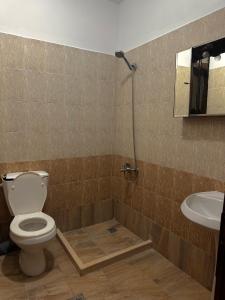 a bathroom with a toilet and a sink at Twins in Korçë