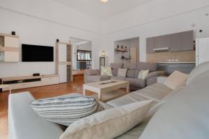 a living room with a couch and a table at Villa Sosha - Carpe Mundi in La Oliva