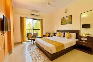 Ένα ή περισσότερα κρεβάτια σε δωμάτιο στο Shivam Beach Resort, Calangute Goa - A Four Star Luxury Retreat