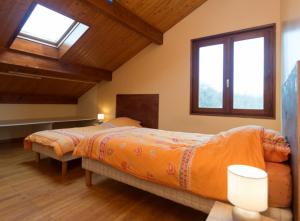a bedroom with a bed and two windows at Gîte Télégraphe, Sonnay in Sonnay
