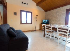 a living room with a table and chairs and a couch at Gîte Télégraphe, Sonnay in Sonnay