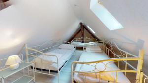 a attic room with two bunk beds and a window at Les Meublés d'Etigny in Luchon
