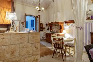 a kitchen with a table and a dining room at Alghero Old Town Gem - Amethyst in Alghero +21 photos