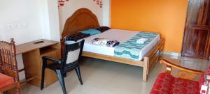 a small bedroom with a small bed and a desk at Mattuppavu Beach House in Vilinjam