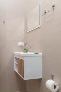 une salle de bain avec un lavabo blanc et des toilettes dans l'établissement Pousada Uchimura, à Itapecerica da Serra 28 autres photos