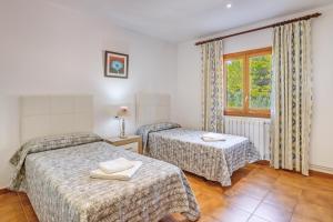 a hotel room with two beds and a window at Villa Luis Vives in Port de Pollensa +22 photos