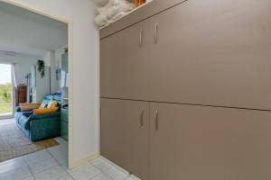 a large cabinet in a living room with a couch at Appartement Cosy face à la mer in Le Croisic
