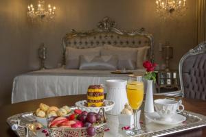 a breakfast table with a tray of fruit and orange juice at CEU PALMAS Hotel in Palmas +48 photos