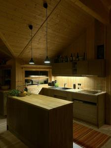 a kitchen with a large island in a room at Ål Cabin With Views Of Marshland And Mountains in Haglebu