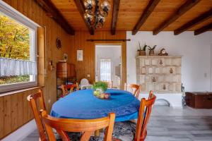 a dining room with a blue table and chairs at Ferien bei Waltraud Weiss in Mendola