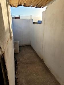 an empty hallway in a building with a window at Zurita Apart in San Fernando del Valle de Catamarca