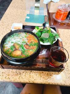 a tray with a bowl of food on a table at Ha Long Homestay in Ha Long