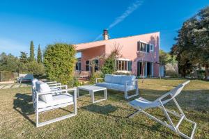 a group of chairs and tables in front of a house at Fontdemalany in Pollença