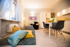 a living room with a kitchen and a dining room at Luxury Boutique Apartment Milan in Milan