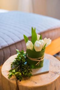a bouquet of white flowers on a wooden table at Luxury Boutique Apartment Milan in Milan
