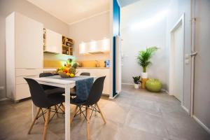 a kitchen and dining room with a table and chairs at Luxury Boutique Apartment Milan in Milan