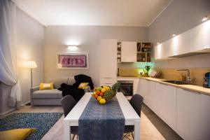 a kitchen and living room with a table with fruit on it at Luxury Boutique Apartment Milan in Milan +28 photos