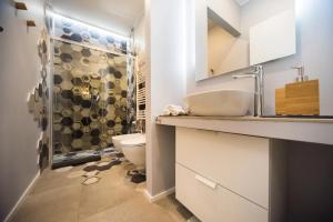 a bathroom with a sink and a toilet and a shower at Luxury Boutique Apartment Milan in Milan
