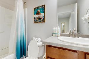 a bathroom with a sink and a toilet and a mirror at Morning Sun 2061B in Big Sky +41 photos