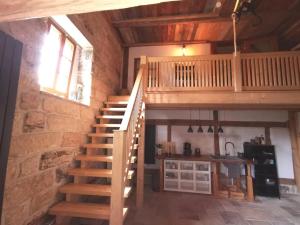 a wooden staircase in a room with a stone wall at Ferienwohnung Galerie in Bad Schandau +11 photos