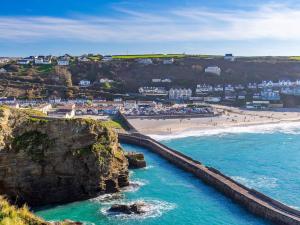 an aerial view of a beach with people on it at 1 Bed in Portreath 93858 in Redruth +8 photos
