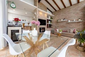 a living room with a glass table and white chairs at Valle de los sueños in Canyelles