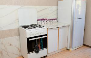 a kitchen with a white stove and a refrigerator at Vardanyan Family Guest House in Shnogh